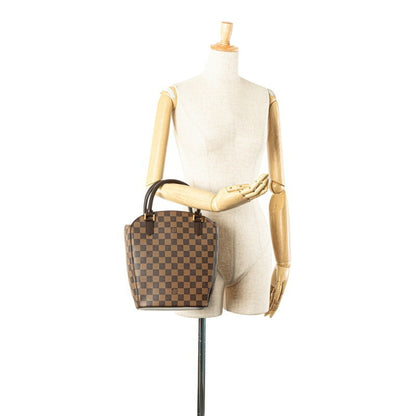 Louis Vuitton Pvc Brown Handbags